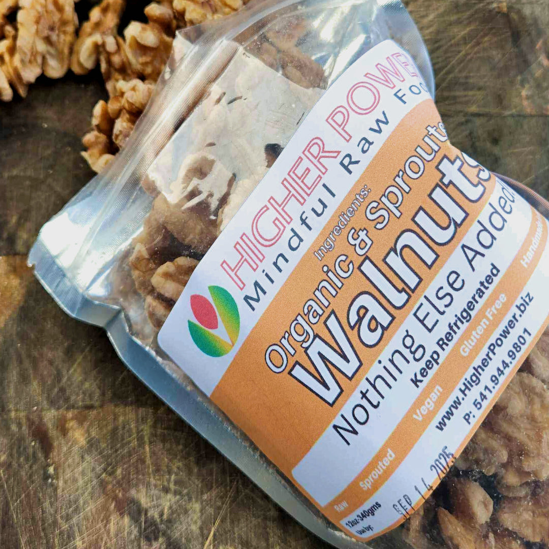 Higher Power Raw Foods Organic Sprouted Walnuts in a bag pouring walnuts on a table.